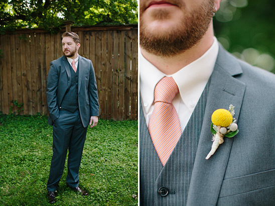 Groom in stylish gray suit with peach tie and flower