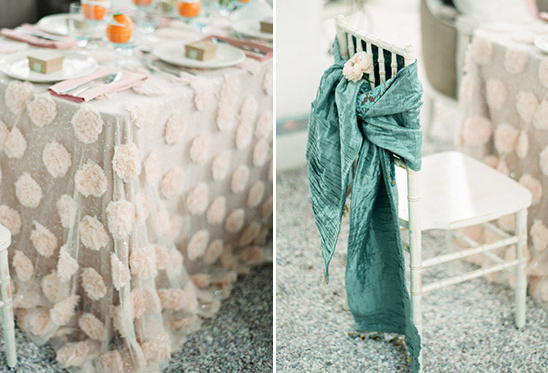 Elegant wedding table decor with floral tablecloth and chair detail