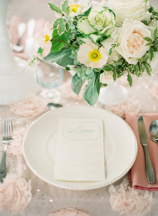 Elegant wedding table setting with flowers and menu card