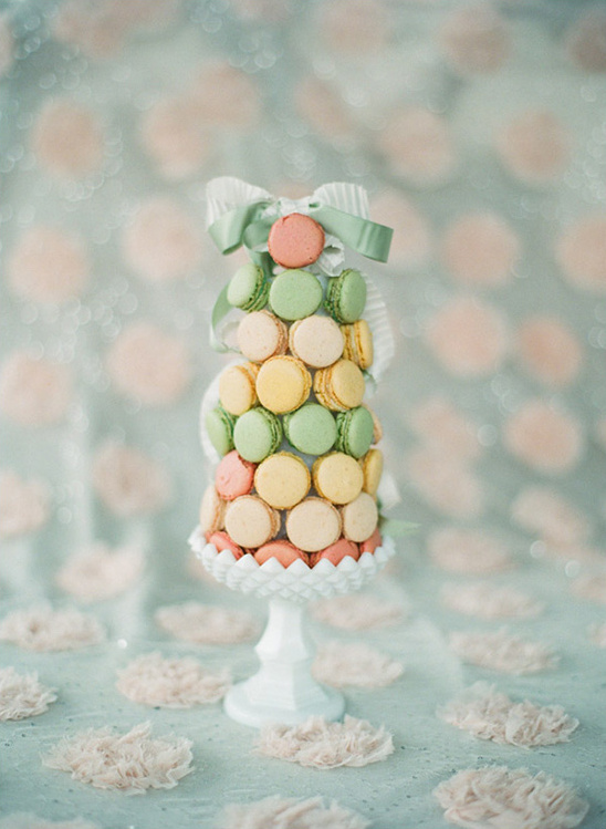 Colorful macaron tower on a white pedestal, a delightful dessert