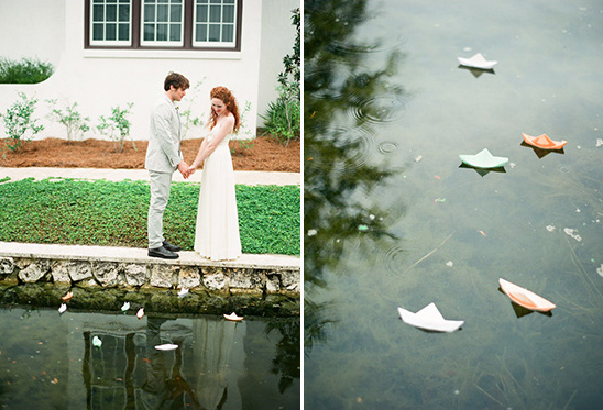 Romantic couple holding hands with paper boats floating in the water