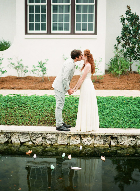 Bride and groom kissing at a beautiful outdoor wedding ceremony