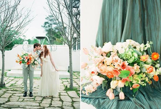 Romantic wedding couple sharing a kiss with vibrant floral bouquet