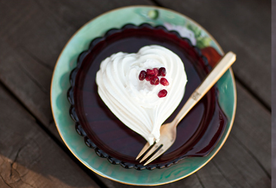 Heart shaped meringue with pomegranate seeds dessert