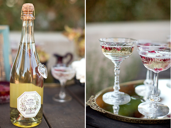 Champagne bottle and coupe glasses with red flower petals