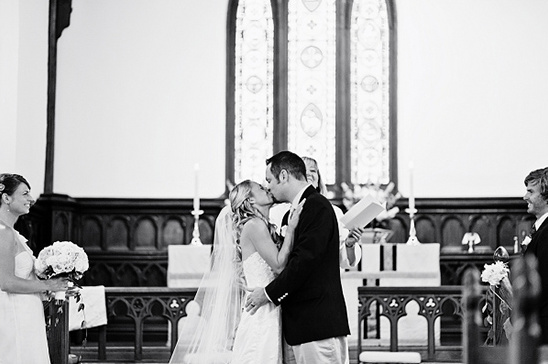 Bride and groom sharing a kiss at their wedding ceremony