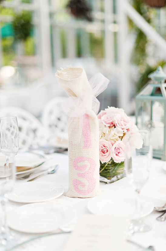 Pink-numbered burlap wine bottle wedding table decor
