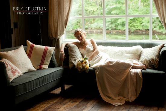 Bride relaxing on couch by window