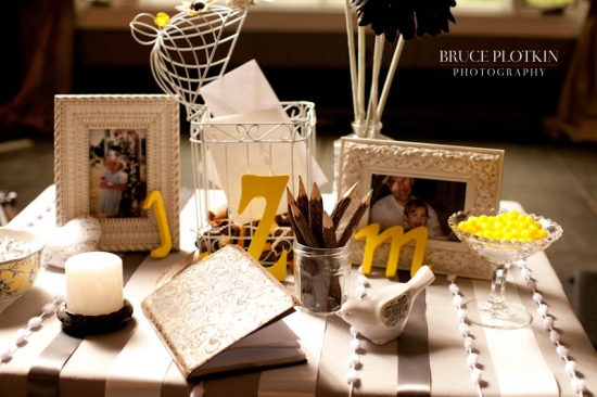 Guest book table with yellow letters and photos