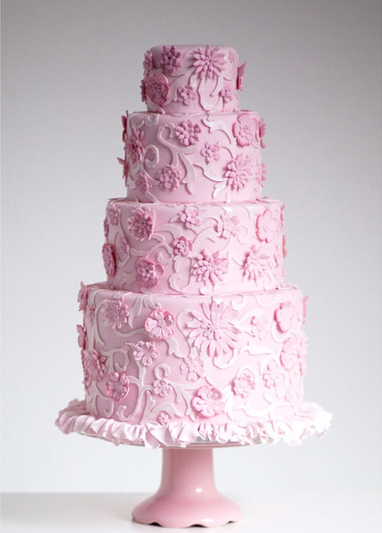 Four tier pink wedding cake with floral decorations