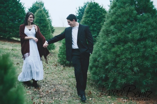 Couple holding hands, strolling through a Christmas tree farm