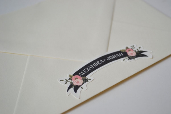 Floral banner names on cream envelope