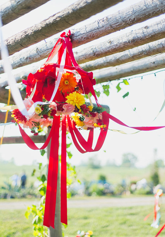 Floral arrangement with red ribbons hanging outdoors