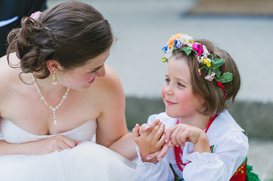 Bride and flower girl sharing a tender moment wedding