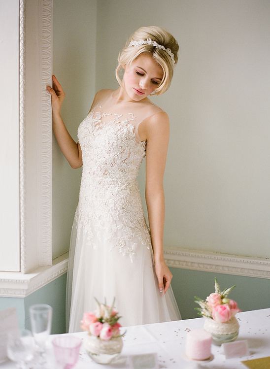 Bride in embroidered tulle wedding dress indoors