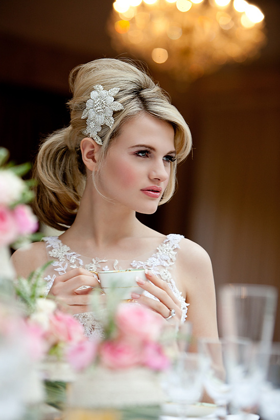 Blonde bride drinks tea with a floral hair accessory