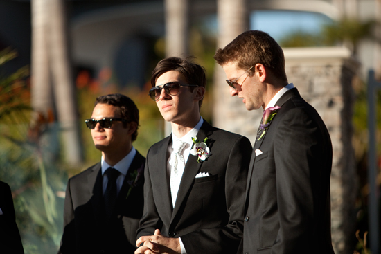 Groomsmen in sunglasses at outdoor wedding ceremony