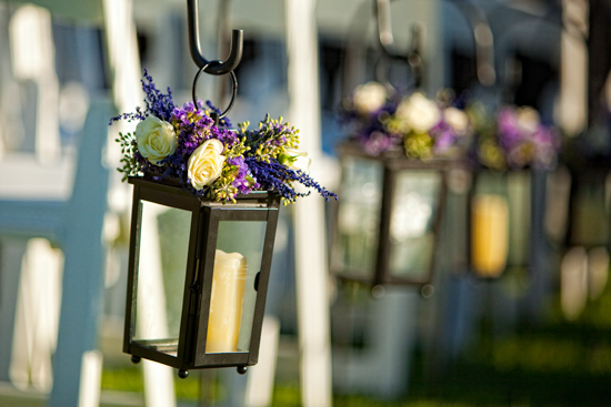 Hanging candle lanterns with floral arrangements for wedding