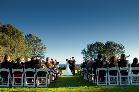 Outdoor wedding ceremony with ocean view backdrop