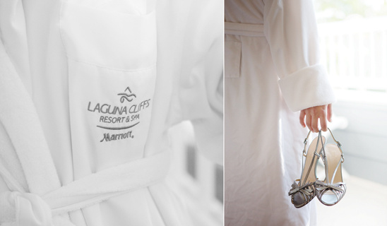 Bride in robe holds shoes at Laguna Cliffs Marriott