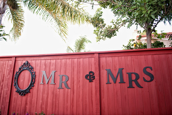 Red fence with Mr & Mrs sign and ornate frame