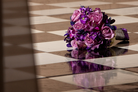 Purple rose bridal bouquet on checkered floor tile