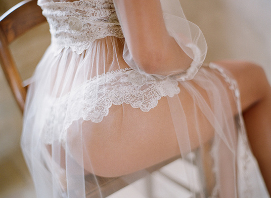 Woman in sheer lace lingerie sitting on a chair