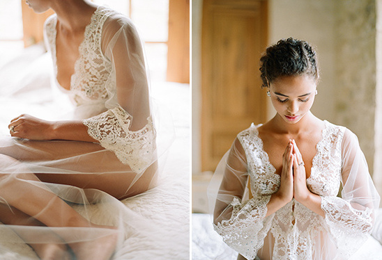 Woman in sheer lace robe meditating peacefully at home