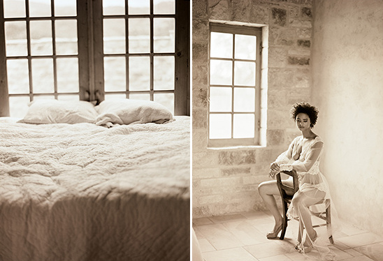 Sepia toned bedroom scene with bed and woman by window