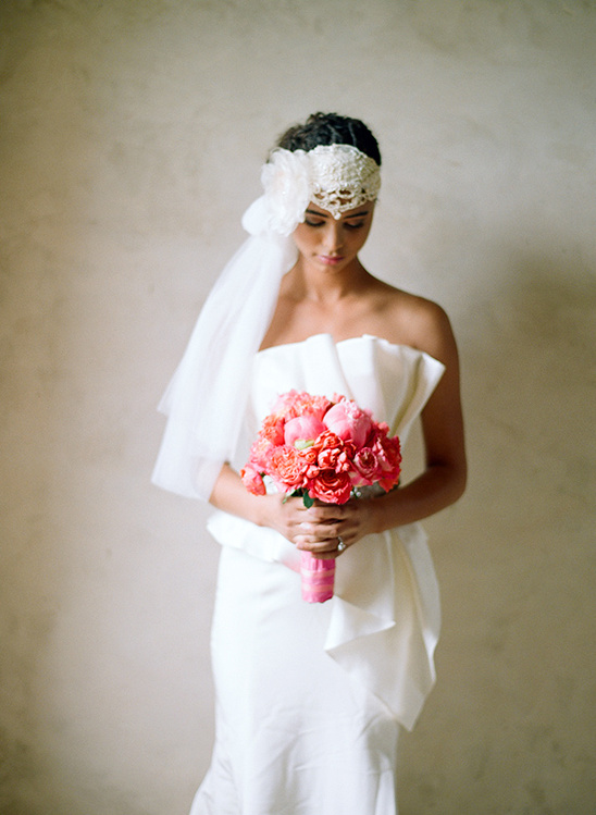 Bride in white dress holding pink peony bouquet