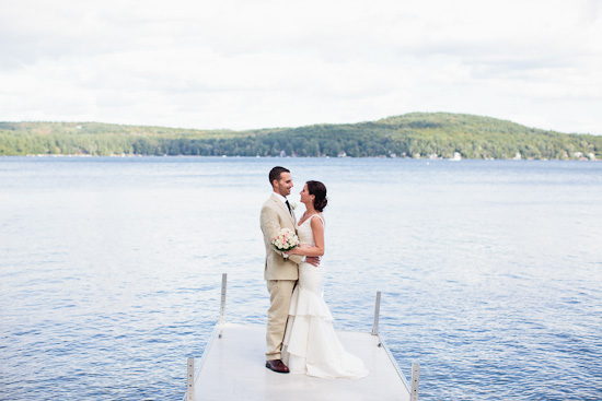 Happy couple embracing on a lake dock
