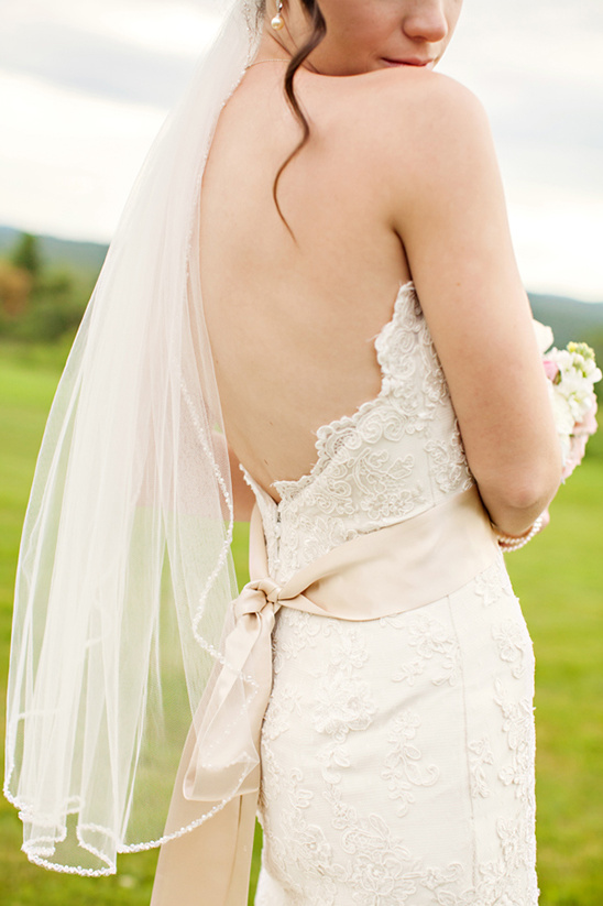 Bride's back view, lace wedding dress, beige sash