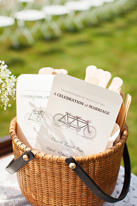 Wedding ceremony programs in a wicker basket