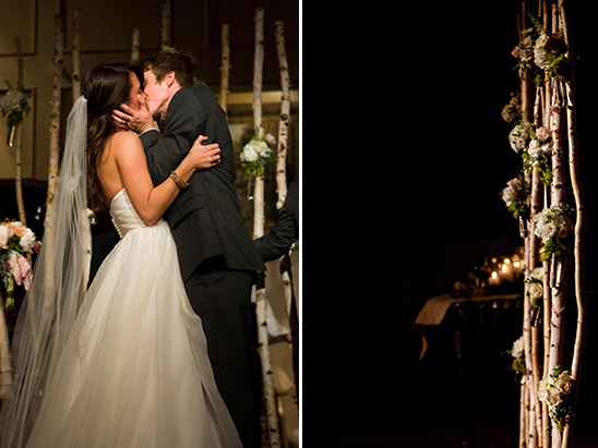Newlyweds share a kiss at their birch tree wedding altar