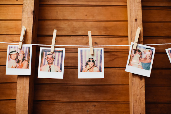 Vintage photos hung on clothesline against wooden wall