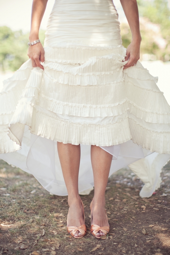 Bride showing off her ruffled wedding dress and shoes