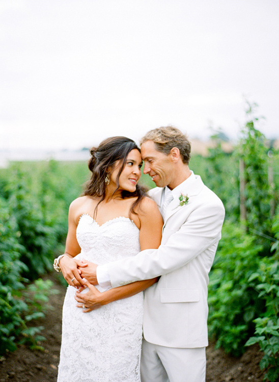 Bride and groom embrace at outdoor wedding venue