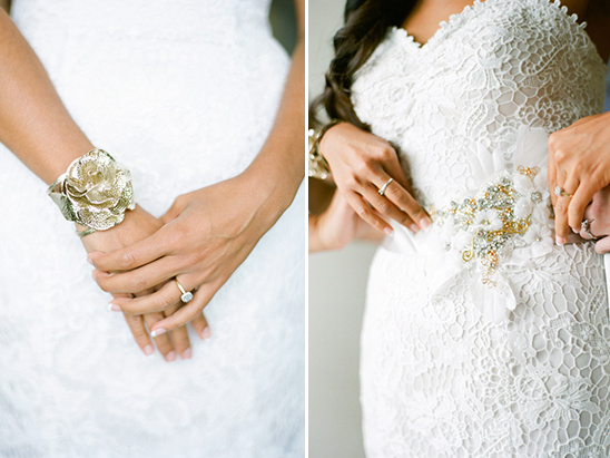 Bride in lace dress adjusts beaded sash detail