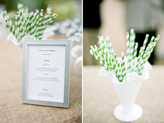Green striped paper straws in white vase at wedding