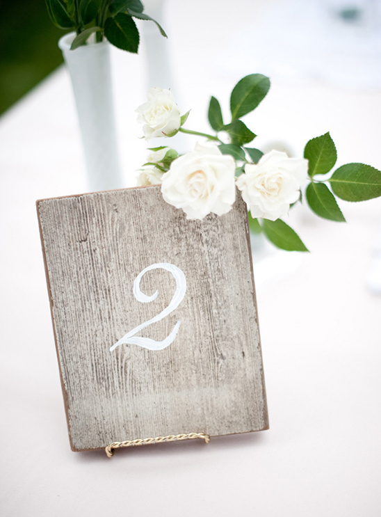 Rustic wedding table number two with white roses