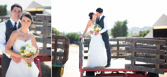 Newlyweds embrace on rustic farm truck at wedding