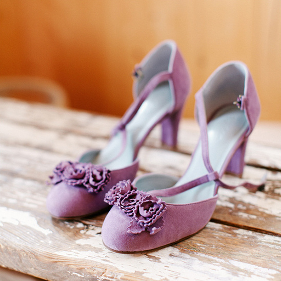 Purple suede heels with floral embellishments