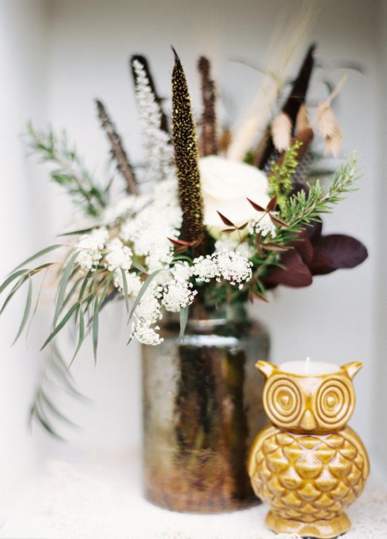 Elegant floral arrangement with owl candle holder