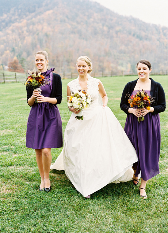 Bride with bridesmaids in purple dresses outdoor wedding