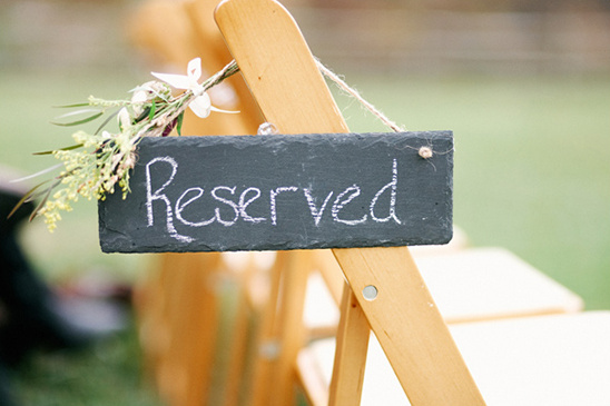 Wedding chair with reserved slate sign and floral decor