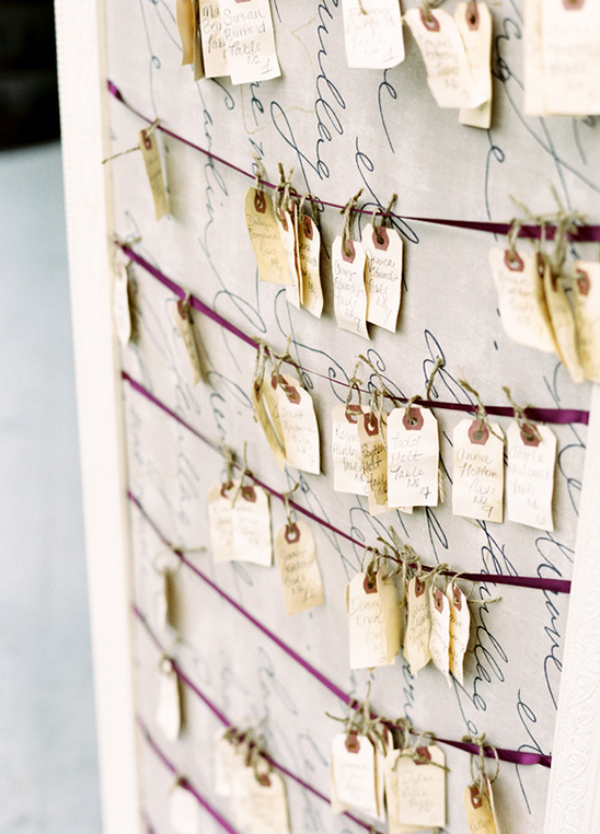 Elegant wedding seating chart with calligraphy backdrop