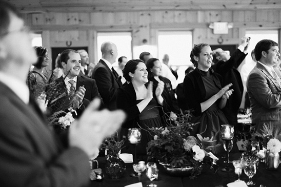 Wedding guests applauding the happy couple
