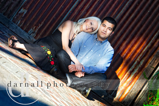 Romantic couple posing against rustic metal backdrop