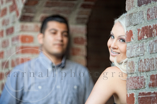 Smiling couple near brick wall