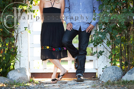 Couple posing by white gate, summer romance